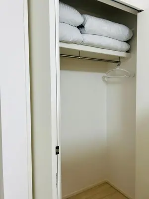 a closet with white towels on a shelf at A newly built house a 4 minute walk from the station, Free parking & Let's enjoy the night view together! in Tokyo
