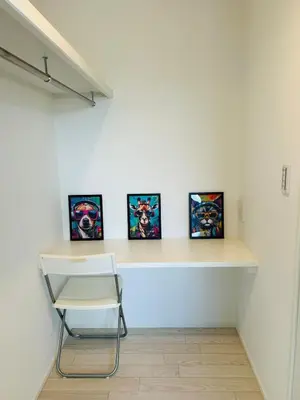 a room with four paintings on a wall with a chair at A newly built house a 4 minute walk from the station, Free parking & Let's enjoy the night view together! in Tokyo