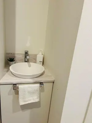 a bathroom with a white sink and a towel at A newly built house a 4 minute walk from the station, Free parking & Let's enjoy the night view together! in Tokyo
