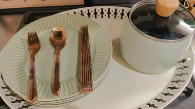 a table with two plates and forks and a cup at Stunning luxury APT with balcony in Tokyo Shinjuku Kabukicho in Tokyo