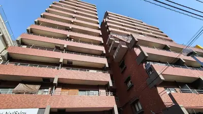 a tall red brick apartment building with balconies at Stunning luxury APT with balcony in Tokyo Shinjuku Kabukicho in Tokyo