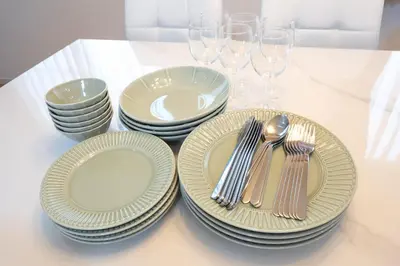 a table with plates and silverware and wine glasses at 4 \u5367\u5ba4 - 3 \u6d74\u5ba4 - 3 \u536b\u751f\u95f4 - 100 \u5e73\u65b9 \u65b0\u88c5 \u522b\u5885 - \u65b0\u5bbf 4 \u5206\u949f - Sakura House in Tokyo