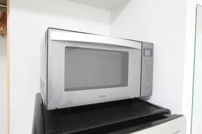 a microwave oven sitting on top of a shelf at LUANA in SHINJUKU in Tokyo