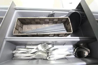 a drawer filled with silver utensils in a sink at LUANA in SHINJUKU in Tokyo