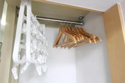 a closet with a rack of baseball bats at LUANA in SHINJUKU in Tokyo