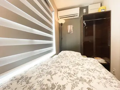 a small bedroom with a bed in a room at ToYo House\u4ee3\u3005\u6728 in Tokyo