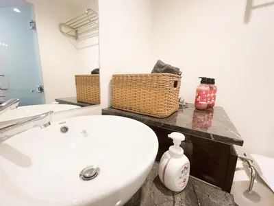 a bathroom with a white sink and a mirror at ToYo House\u4ee3\u3005\u6728 in Tokyo