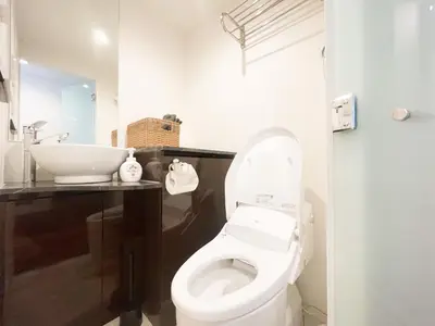 a bathroom with a white toilet and a sink at ToYo House\u4ee3\u3005\u6728 in Tokyo