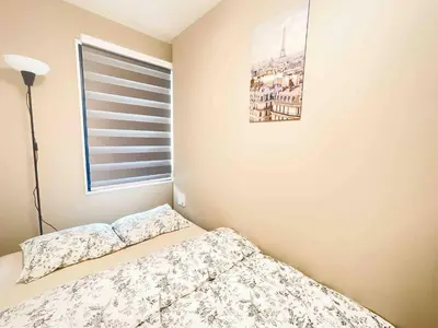 a bedroom with a bed and a window at ToYo House\u4ee3\u3005\u6728 in Tokyo