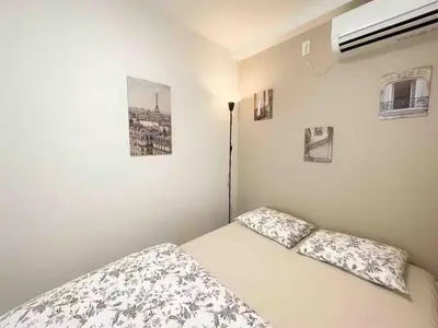 a white bedroom with a bed with two pillows at ToYo House\u4ee3\u3005\u6728 in Tokyo