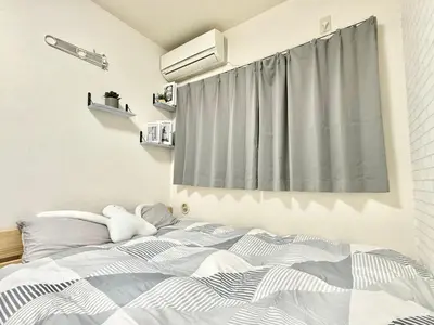 a bedroom with a bed with a teddy bear on it at Shinjuku \u9ad8\u7530\u99ac\u5834T AC in Tokyo