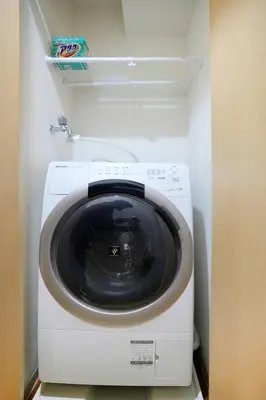a washer and dryer in a small room at LJ Hotel Shinjuku in Tokyo