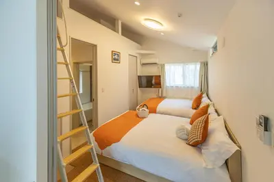 a small bedroom with a bed and a ladder at DUA \u795e\u697d\u5742Shinjuku area,train 3 mins,waseda,Kagurazaka in Tokyo