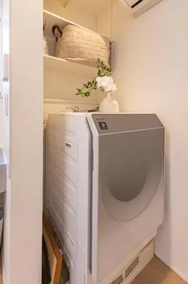 a white washer and dryer in a room at DUA \u795e\u697d\u5742Shinjuku area,train 3 mins,waseda,Kagurazaka in Tokyo