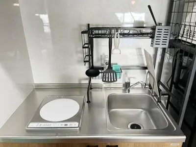 a small kitchen with a sink and a counter top at jtr\u6d45\u8349\u6a4b502 in Tokyo