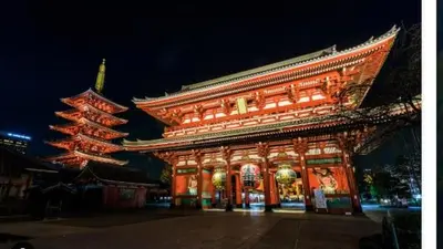 a large building with lights on it at night at jtr\u6d45\u8349\u6a4b502 in Tokyo