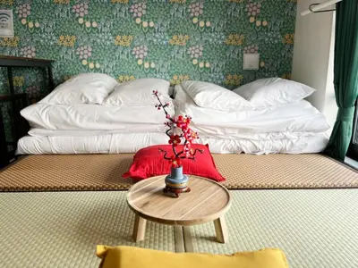 a room with a bed and a table with a pillow at jtr\u6d45\u8349\u6a4b501 in Tokyo