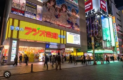 a group of people walking in a city at night at jtr\u6d45\u8349\u6a4b501 in Tokyo