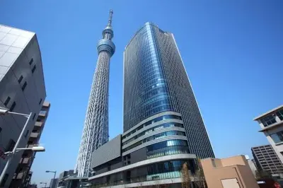 a view of two tall buildings in a city at jtr\u6d45\u8349\u6a4b501 in Tokyo