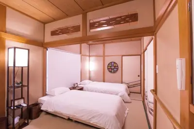 a bedroom with two beds and a large mirror at \uff26\uff55\uff57\uff41\uff26\uff55\uff57\uff41 in Tokyo