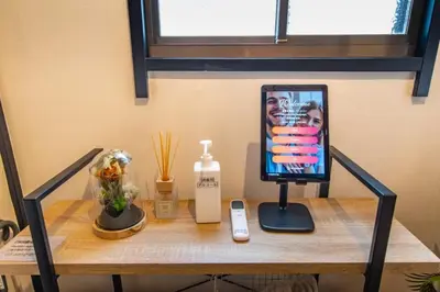 a table with a cell phone and a picture on it at \uff26\uff55\uff57\uff41\uff26\uff55\uff57\uff41 in Tokyo