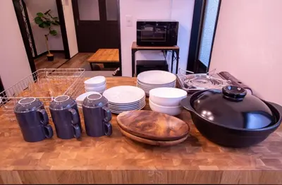 a table with plates and a bowl on a table with a mortar and pestle at \uff26\uff55\uff57\uff41\uff26\uff55\uff57\uff41 in Tokyo