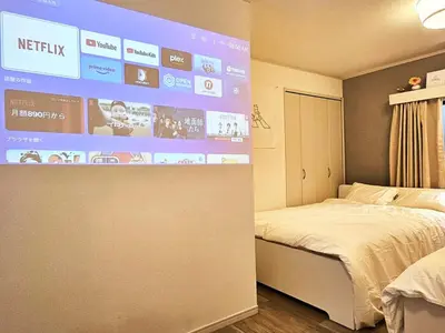 a room with a bed and a large screen at New #\ud3b8\uc758\uc81010\ucd08#\uc2e0\uc8fc\ucfe02\ubd84#\uc2e0\uc624\ucfe0\ubcf4\uc5ed5\ubd84#16\ud3c9#\ucd5c\ub3004\uba85#\ubd80\uc5cc\uce68\uc2e4#\ub098\ub9ac\ud0c0\uacf5\ud56d50\ubd84#\uc544\ub291\ud55c\uc544\ud30c\ud2b8#\uace0\uae09\ub9e4\ud2b8\ub9ac\uc2a4 in Tokyo