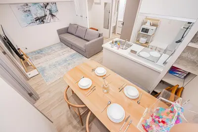 a living room with a table and a couch at self-check in misimaya building in Tokyo