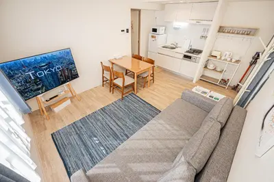 a living room with a couch and a table at self-check in misimaya building in Tokyo