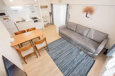 a living room with a couch and a table at self-check in misimaya building in Tokyo