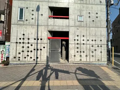 a shadow of a person standing in front of a building at \u5de3\u9d28Sapmt in Tokyo