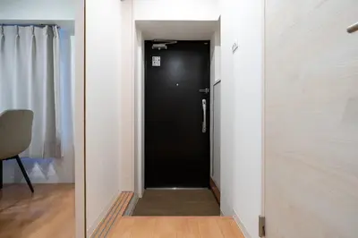 a hallway with a black door in a room at MAT ARAIYAKUSHI West in Tokyo
