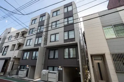 an apartment building on a city street at MAT ARAIYAKUSHI West in Tokyo