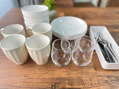 a group of wine glasses and plates on a table at 6 Min Walk from Aoto Station, Direct Access to Narita, Haneda Airports, Old house with modern renovation, in Tokyo