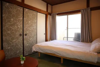 a bedroom with a bed and a window at 6 Min Walk from Aoto Station, Direct Access to Narita, Haneda Airports, Old house with modern renovation, in Tokyo