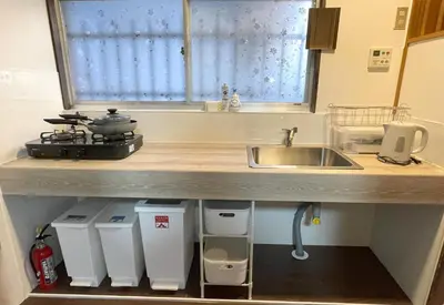 a kitchen with a sink and a counter top with a sink at 6 Min Walk from Aoto Station, Direct Access to Narita, Haneda Airports, Old house with modern renovation, in Tokyo