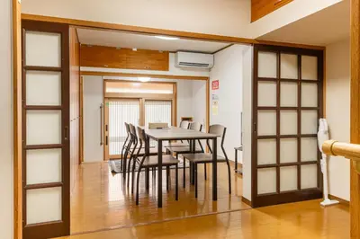 a dining room with a table and chairs at \u6d45\u8349\u4e09\u4e01\u76ee\u6238\u5efa\u3066 in Tokyo