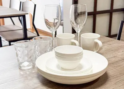 a table with plates and glasses on a table at \u6d45\u8349\u4e09\u4e01\u76ee\u6238\u5efa\u3066 in Tokyo
