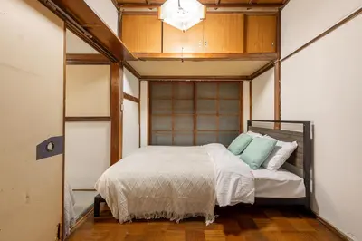 a bedroom with a bed in a room at \u6d45\u8349\u4e09\u4e01\u76ee\u6238\u5efa\u3066 in Tokyo