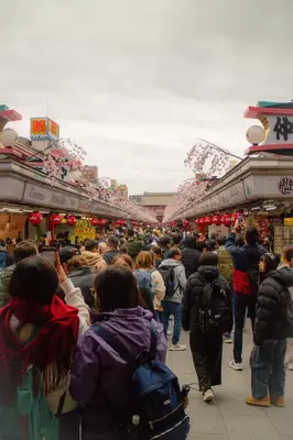 a large crowd of people walking through a market at Ace Inn Asakusa in Tokyo