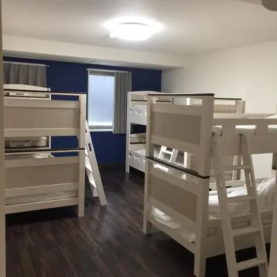 a room with two bunk beds and a window at Ace Inn Asakusa in Tokyo
