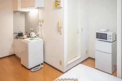 a kitchen with a refrigerator and a microwave at shinjuku 2 stops,3-4 people,train walk for 5mins in Tokyo