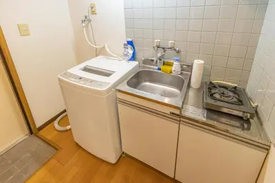 a small kitchen with a sink and a stove at shinjuku 2 stops,3-4 people,train walk for 5mins in Tokyo