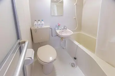 a bathroom with a toilet and a sink and a tub at shinjuku 2 stops,3-4 people,train walk for 5mins in Tokyo