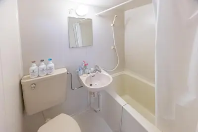 a bathroom with a toilet and a sink and a tub at shinjuku 2 stops,3-4 people,train walk for 5mins in Tokyo