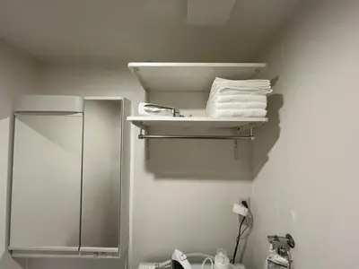 a bathroom with a shower and towels on a shelf at ksf\u4e0a\u6c60\u888b3\u4e01\u76ee102 in Tokyo