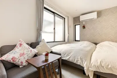 a bedroom with a bed and a couch and a table at ksf\u4e0a\u6c60\u888b3\u4e01\u76ee201 in Tokyo