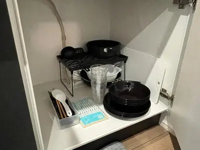 a small refrigerator with a shelf with pots and pans at ksf\u4e0a\u6c60\u888b3\u4e01\u76ee202 in Tokyo
