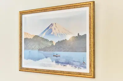 a framed picture of a mountain and a lake at Nomadland Shinagawa Omori 1004 in Tokyo