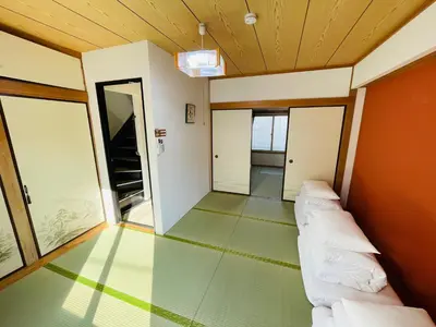 a living room with a couch and a wooden ceiling at Sakae House in Tokyo